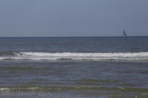 sailboat on the north sea, seen from the shore photo
