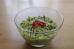 guacamole, Mexican dipping sauce, avocado, tomato, coriander, lemon photo