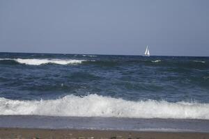 no straight horizon, it feels like you are swaying on the wavessailboat at sea, waves on the coast photo