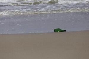 bottle on the shore, message in a bottle photo