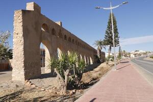 roman aqueduct in antas, spain photo