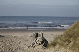 wooden mile markers on the beach with ship cables, photo