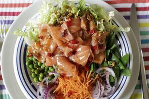 poke bowl with sugarsnaps, peas, red onion, carrot salad, salmon photo