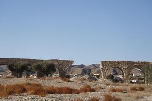 roman aqueduct in antas, spain photo