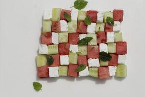 mosaic of a salad of watermelon, cucumber, feta cheese, mint, lime photo