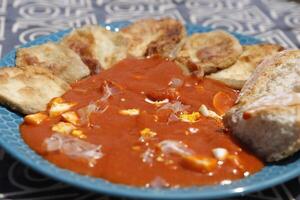 spanish food, baked eggplant with cold tomato soup called salmorejo with boiled egg and raw ham photo