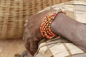 arm with bracelets of a tata somba woman photo