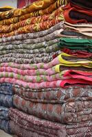 blankets and mattresses for sale on the market in Varanasi, India photo