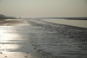 amazing, never seen it before, ice on the salt water and sand, beach, north sea,winter in the netherlands photo