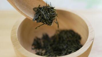 Spoon of Dry Green Tea leaves are poured in Small Bowel video