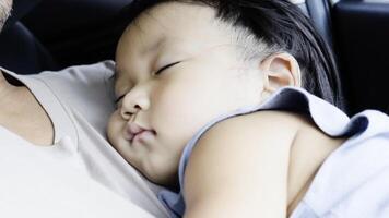 Baby asleep on his father. Father holding his sleeping son video