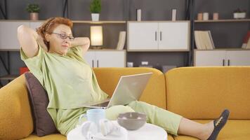 Retired woman resting at home, she relaxes. video