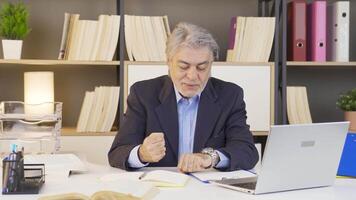 Businessman constantly looking at his watch. video