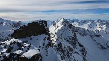 Aerial view of Cheget mountain range in snow in winter in sunny clear weather video