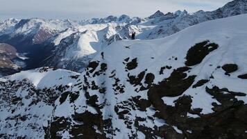 Aerial view of Cheget mountain range in snow in winter in sunny clear weather video