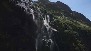 l'eau les flux vers le bas le pente de une Montagne gouttes éclaboussure de une énorme Roche video