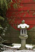 snow in the garden, japanese lantern photo