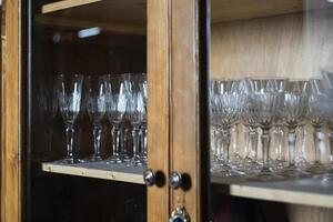 Antique glasses inside the cupboard photo