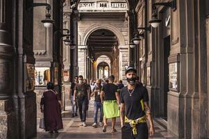 BOLOGNA ITALY 17 JUNE 2020 People walking under Bologna s Arcades in Italy photo