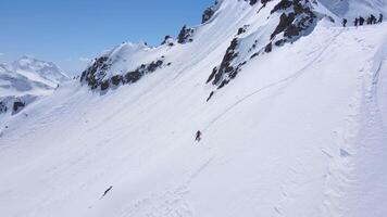 Person skiing down snowcovered mountain slope for a recreational thrill video