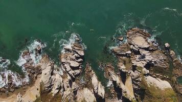 Coastal rocky shore with crashing waves viewed from above video