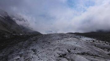 Breathtaking scenery of the Bezengi Glacier in the Bezengi Gorge. Snow-capped mountains. Wild untouched nature of the Caucasus Mountains. Bezengi Gorge. White clouds Aerial view video