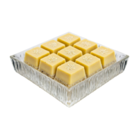 Barfi creamy squares garnished with silver leaf in a transparent glass bowl png