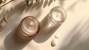 Close up of two jars of facial cream with a white flower. photo