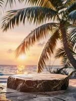 A stone pedestal on a stone slab in front of palm trees and the ocean at sunset. photo