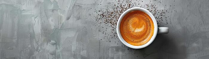 White cup of coffee on a gray stone background. photo