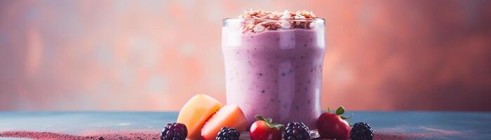 A glass of pink smoothie next to fresh apricots, strawberries and blackberries. photo