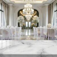 An empty marble table with a blurred background of a wedding reception hall. photo