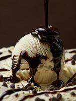 Rich and creamy vanilla ice cream topped with decadent chocolate sauce. photo