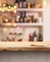 An empty wooden table with a wooden cutting board on it. The background is a blurred image of a bar. photo