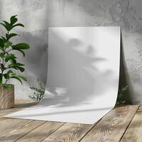 White paper on wooden floor with plant shadows. photo
