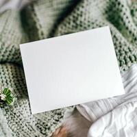 Blank paper on a soft green blanket. Perfect for writing a letter, making a card, or taking notes. photo