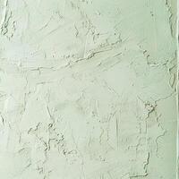 Sage green textured background with a rough plaster or concrete surface. photo