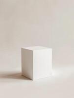 A white cube on a beige background. photo