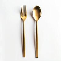Gold shiny fork and spoon isolated on white background. photo