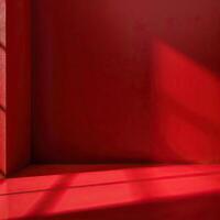 red room with a single light shining through a window. The room is empty and has a minimalist design. photo