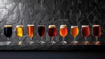 Craft beers in different glasses on a dark stone background. photo