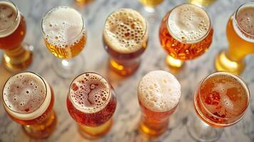 glasses of different beers on marble table photo