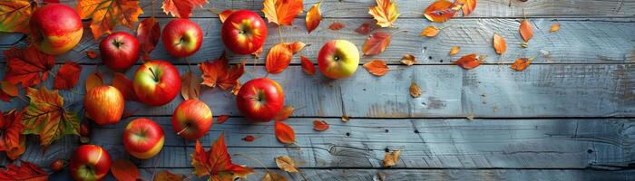 A dynamic angle capturing a festive scene of apples, pumpkins, and autumn leaves spread across a weathered wooden deck, vibrant colors in focus, set against a clean, minimalist bac photo