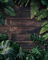 top view of a wooden table, with tropical plants and leaves around it photo