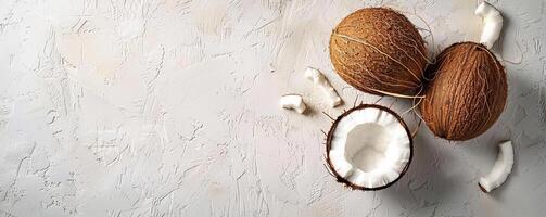 milky white background with three coconuts, a lot of empty space photo