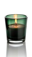 a Burning aroma candle in the beautiful darkgreen glass on the white background photo