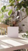 a greeting card on a table, simple white room, nature vibes for a mock up photo