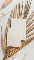 a Beautiful ultra minimalistic boho style of A4 and thank you cards blank invitation mockup in diagonal on a palm leaf with a boho neutral and white color background photo