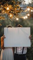 a wedding couple holding a white canvas photo