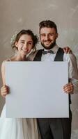 a wedding couple holding a white canvas photo